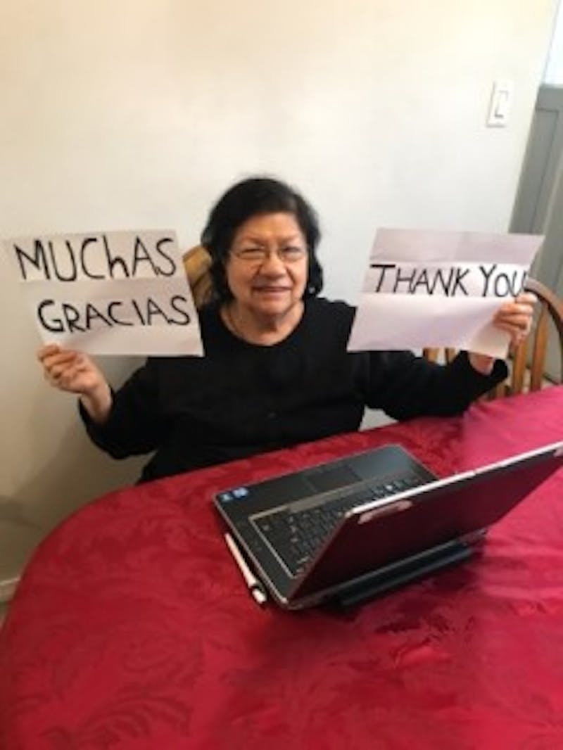 Woman with a laptop holding signs that say