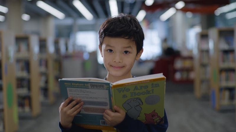 A child holds a book.