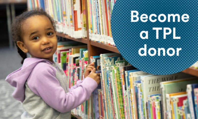 A child in front of a bookshelf. There's a bubble in the top right with a blue background and white polka dots with the words