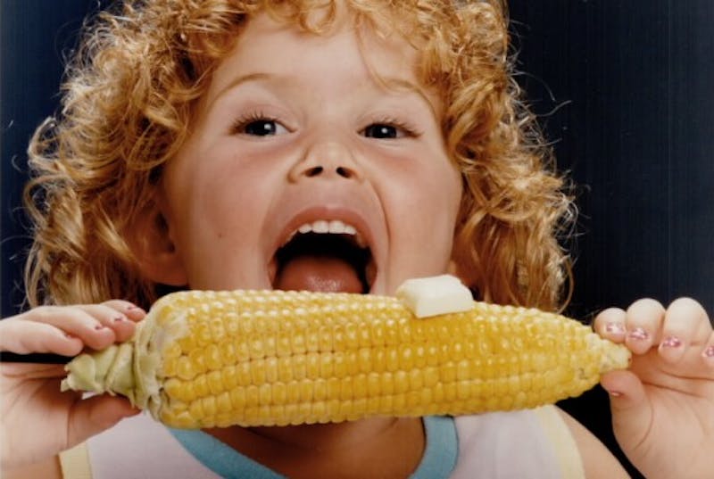 Child eating corn