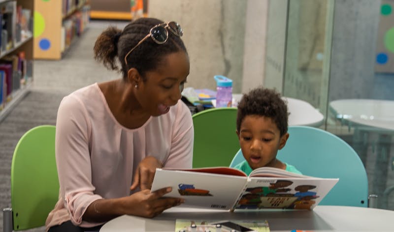 Woman and child reading a book.