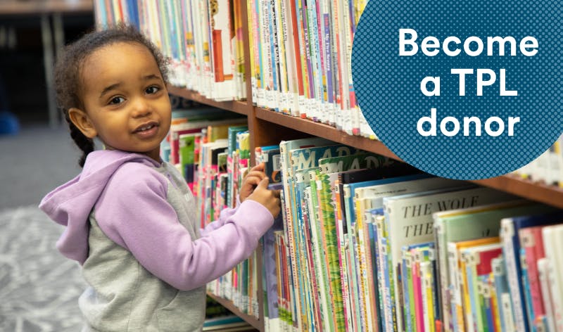 Kid grabbing a library book
