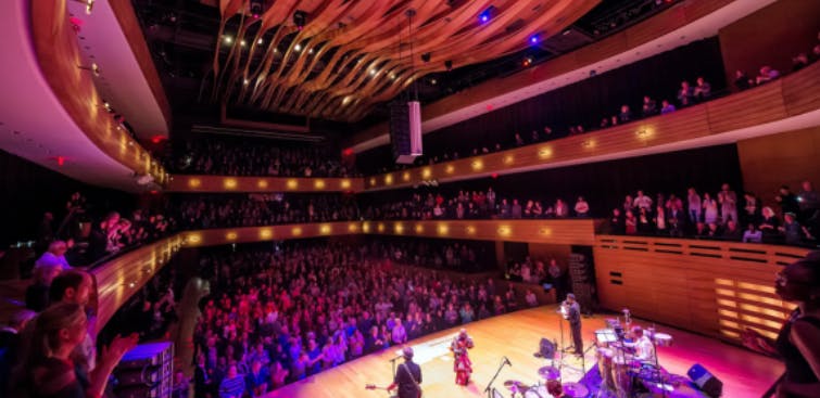 Interior view of the Royal Conservatory of Music venue with musicians playing.