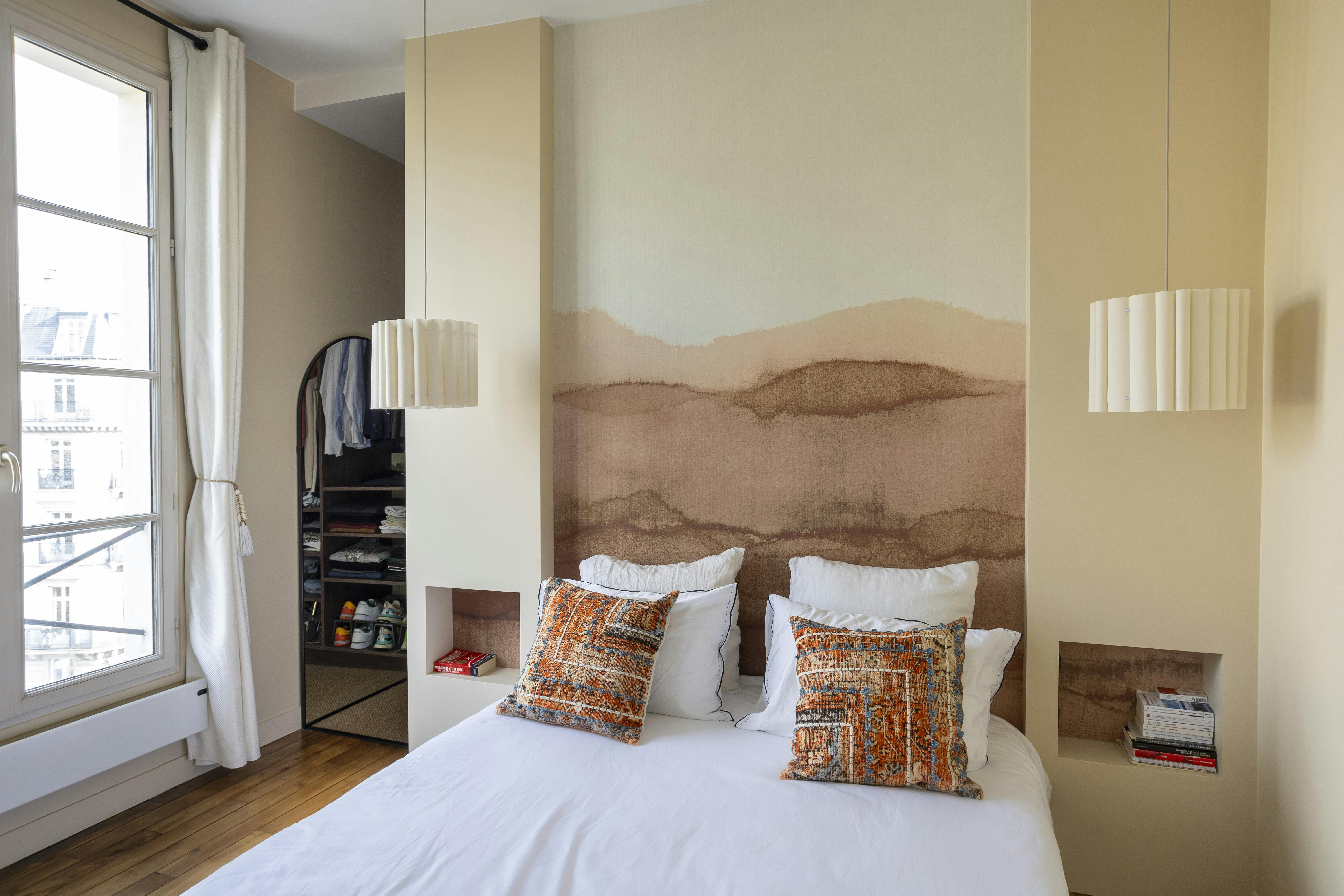 Une chambre chaleureuse avec un mur décoratif aux tons terre cuite.