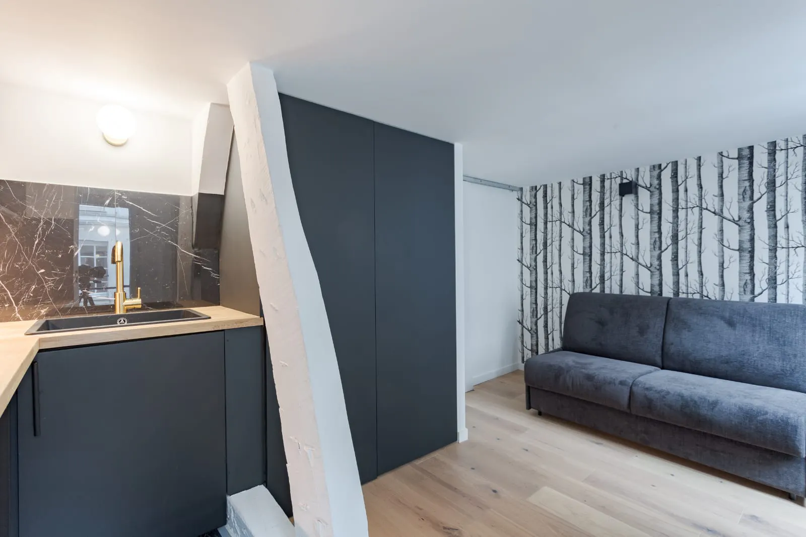 Séjour et coin cuisine avec poutres apparentes studio 15 m²