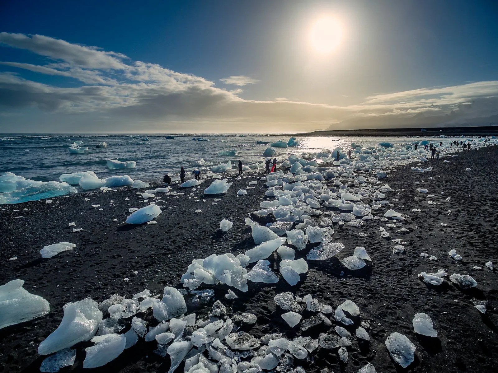 people walking amongs ice by Jokulsarlon glacier lagoon