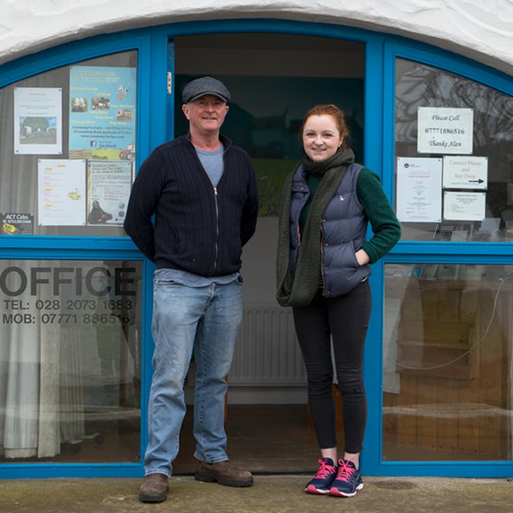 alan and claire standing in front of their property