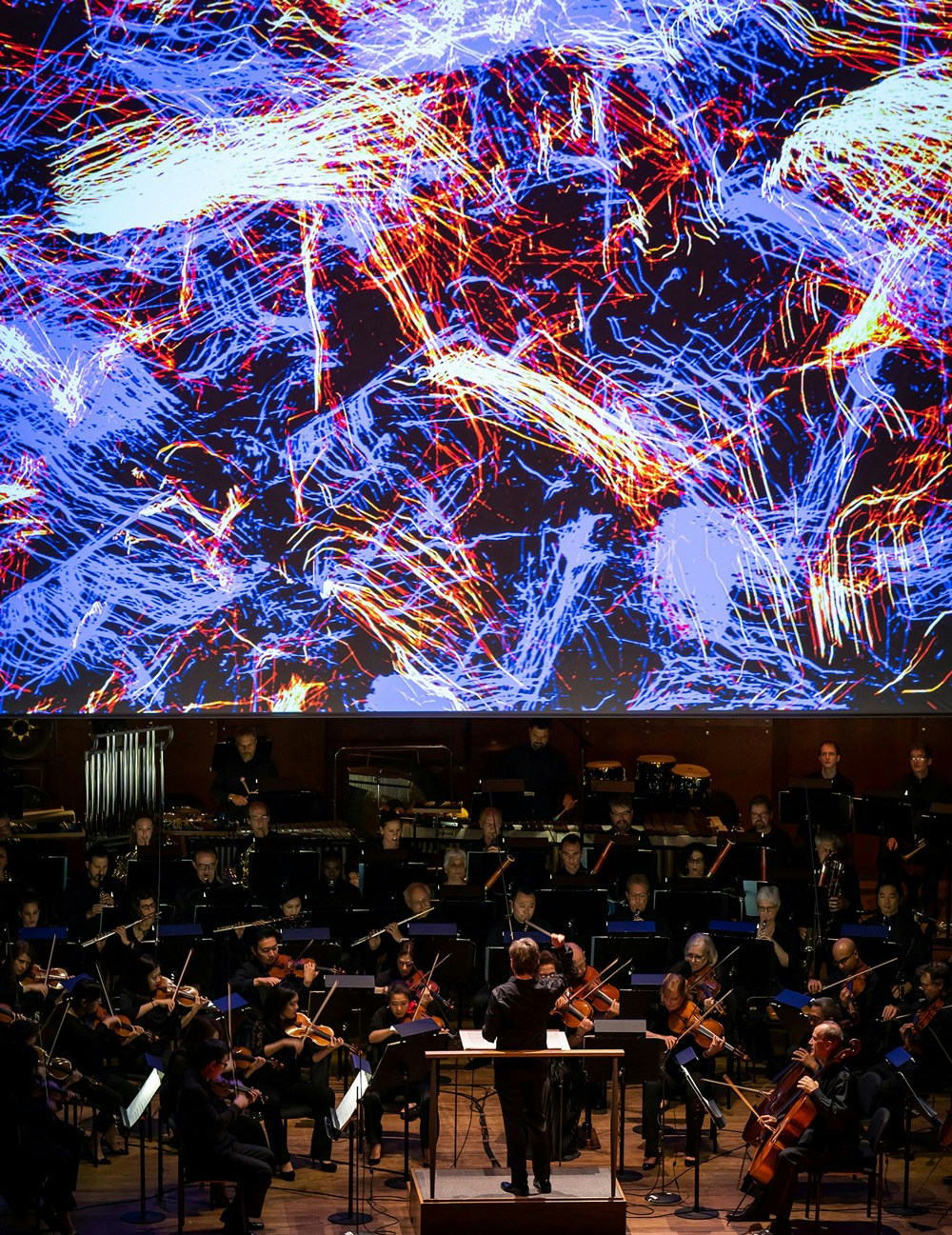 Foreign Bodies New York Philharmonic 2018 blue red particles