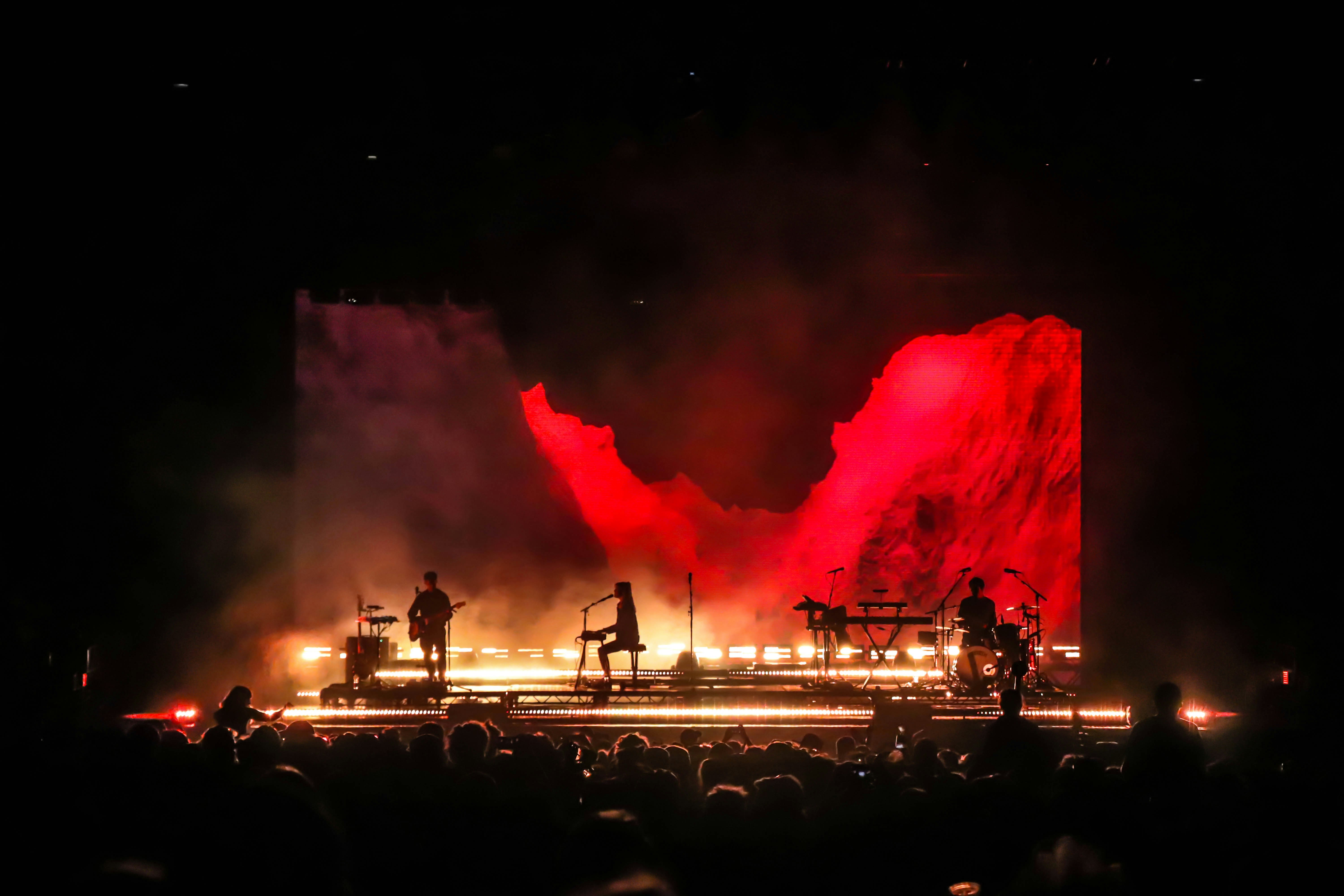 London Grammar live at Bestival 2019 Stage shot with red mountains on-screen