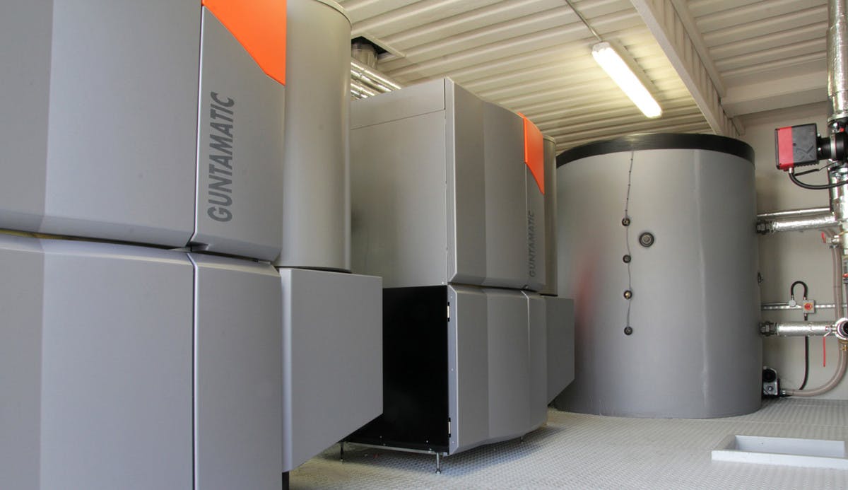 Guntamatic biomass boilers inside a containerised boiler plant room