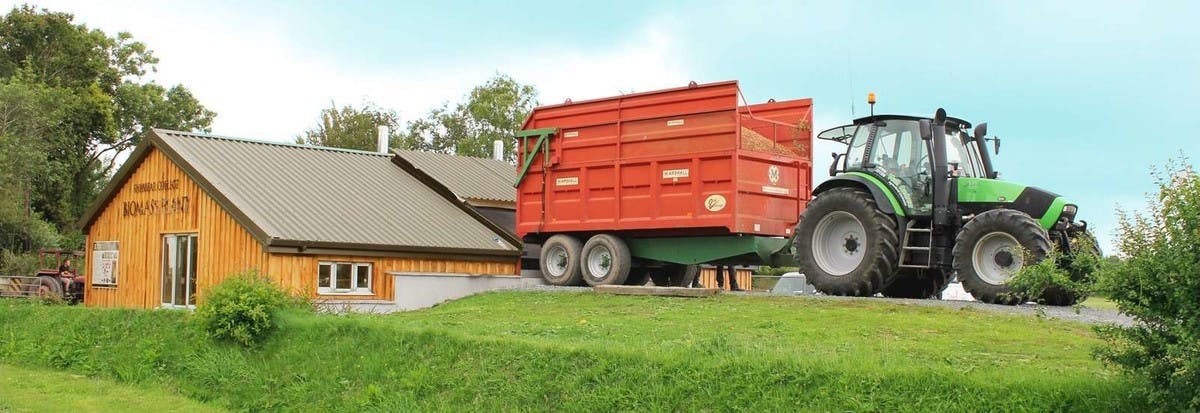 A tractor loading fuel at Shebbear College's Biomass Plant installed by Treco