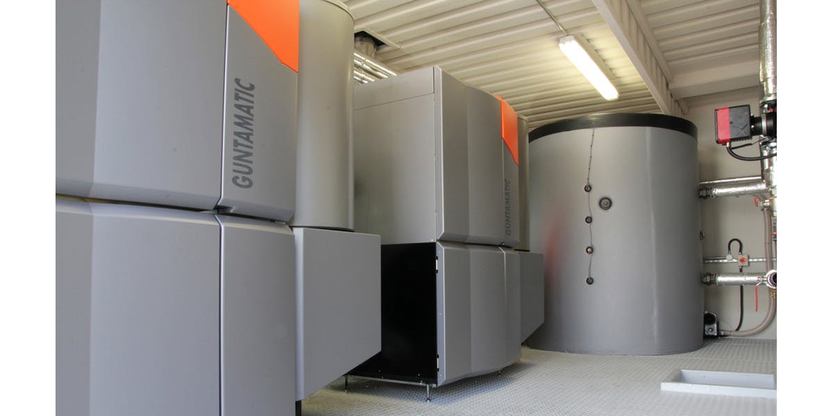 Guntamatic biomass boilers inside a containerised boiler plant room