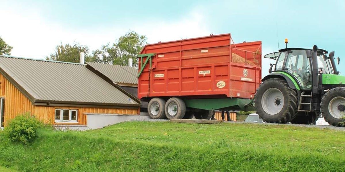 A tractor loading fuel at Shebbear College's Biomass Plant installed by Treco