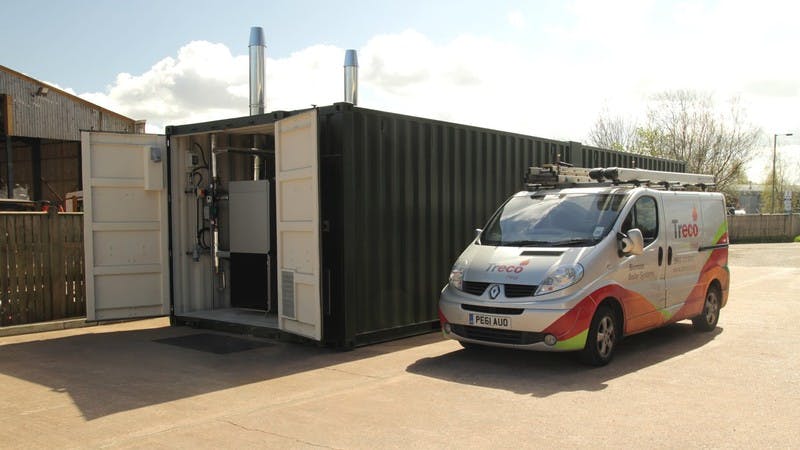 A containerised boiler plant room solution next to a Treco van