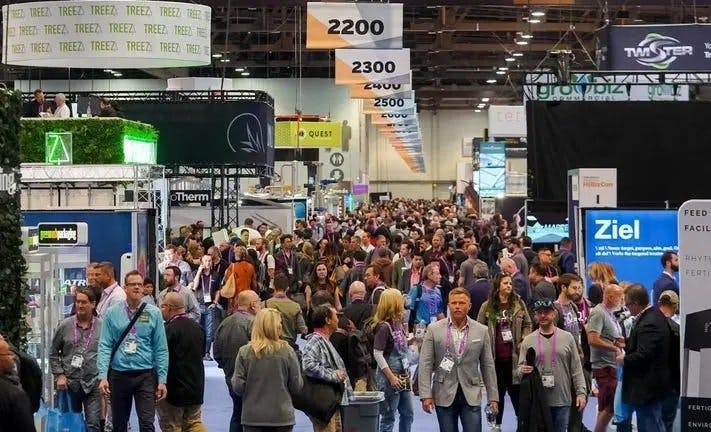 A packed conference floor with hundreds of attendees, the Treez logo is featured prominently in the foreground