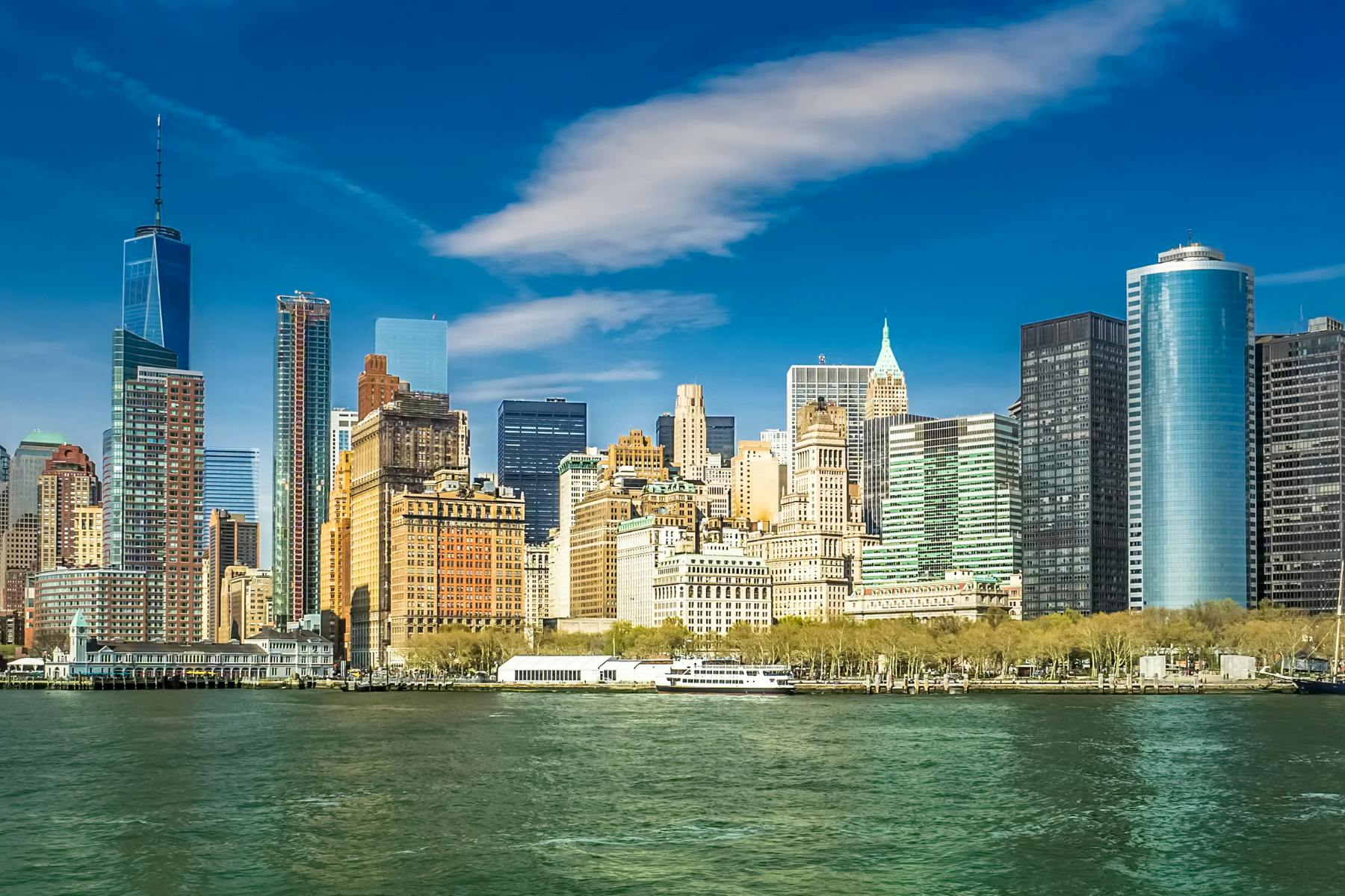 The New York skyline is seen against a dark green river