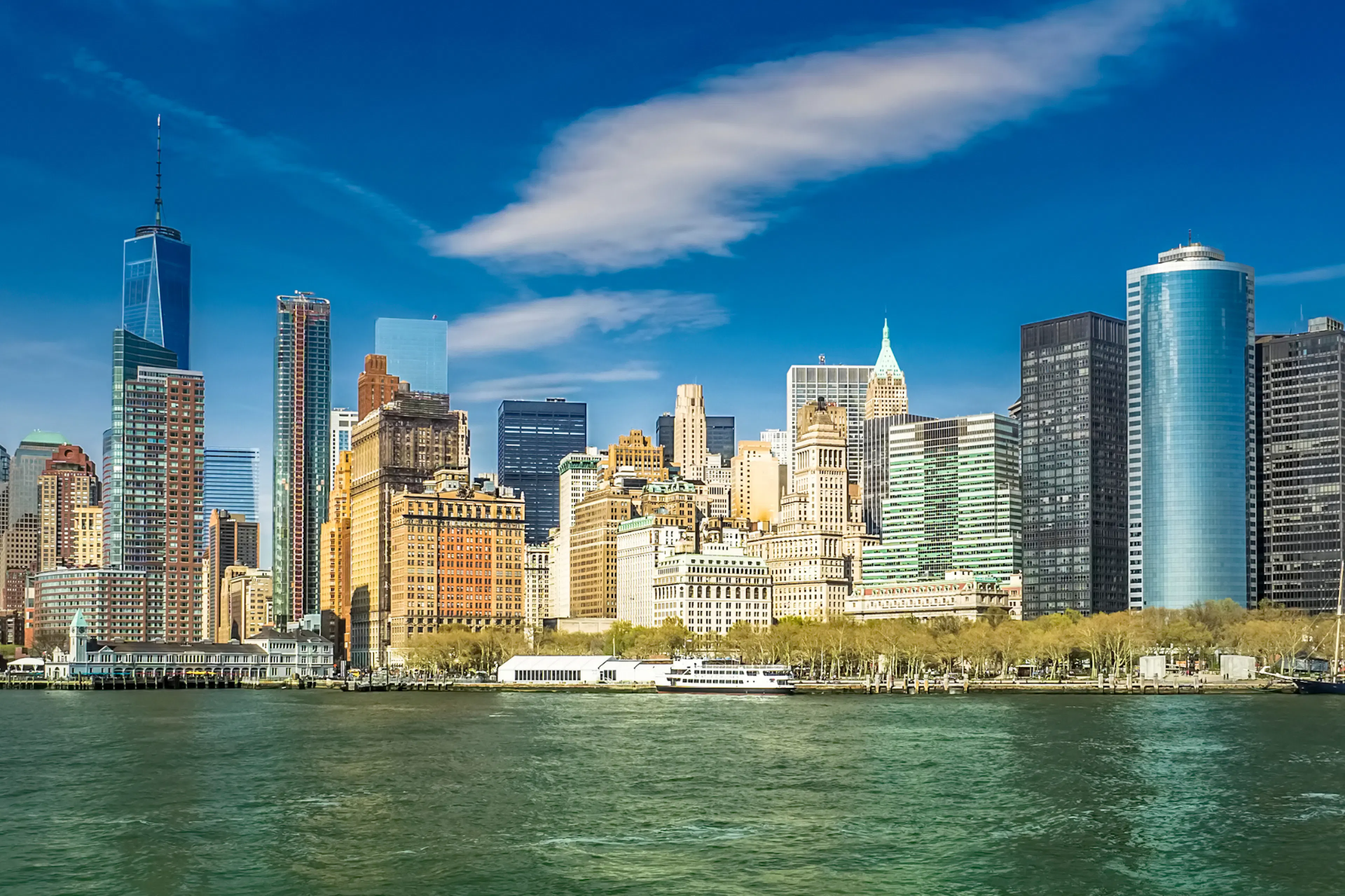 The New York skyline is seen against a dark green river