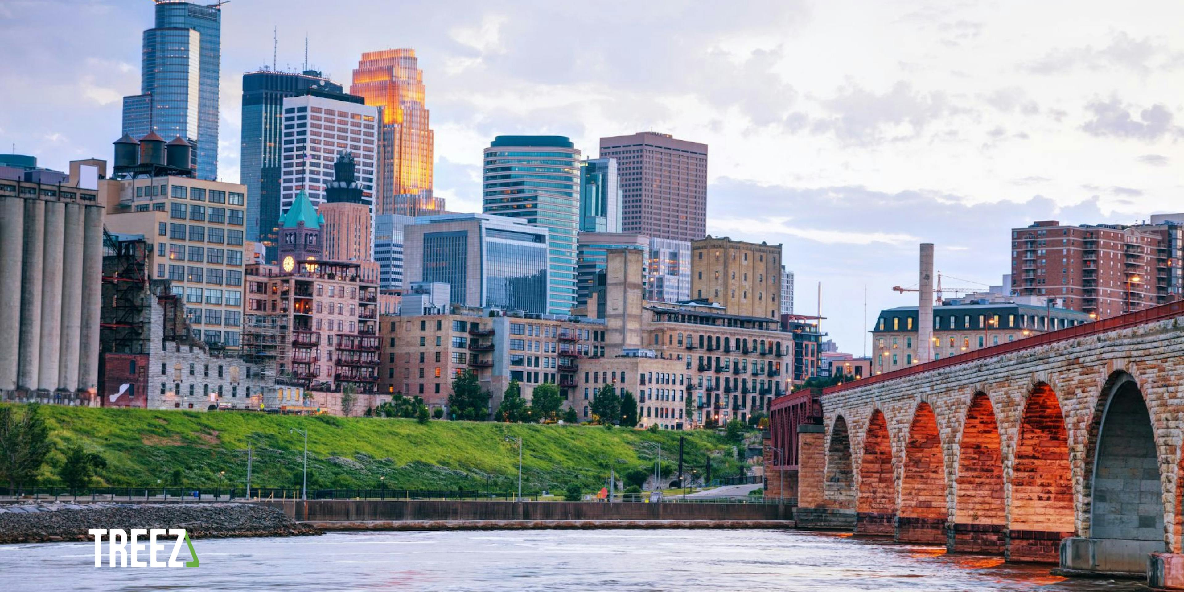 A sunset photo of Minneapolis is shown with a logo of Treez, the cannabis point of sale system and payments processing company