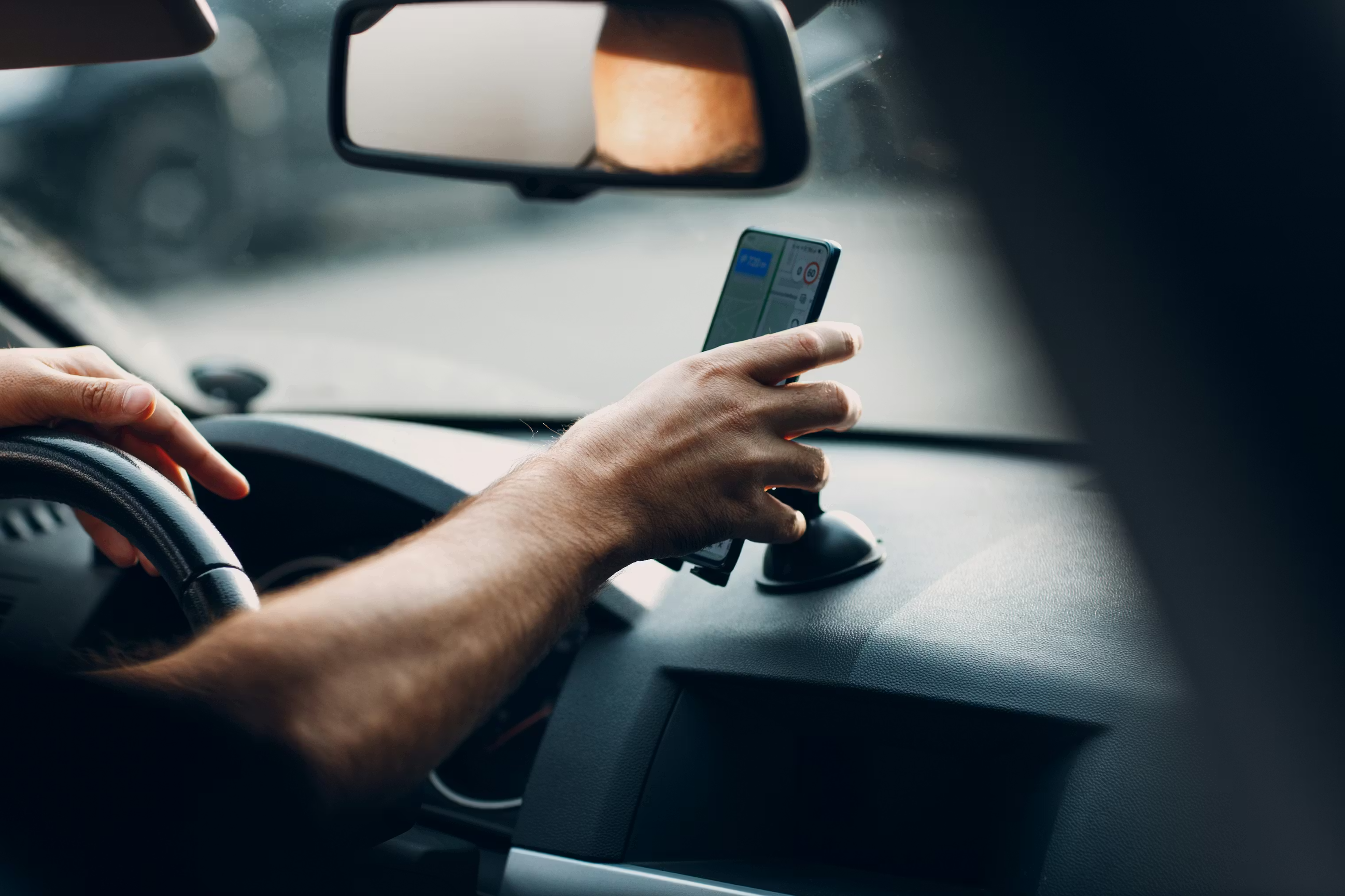 Driver using GPS navigation on smartphone while driving