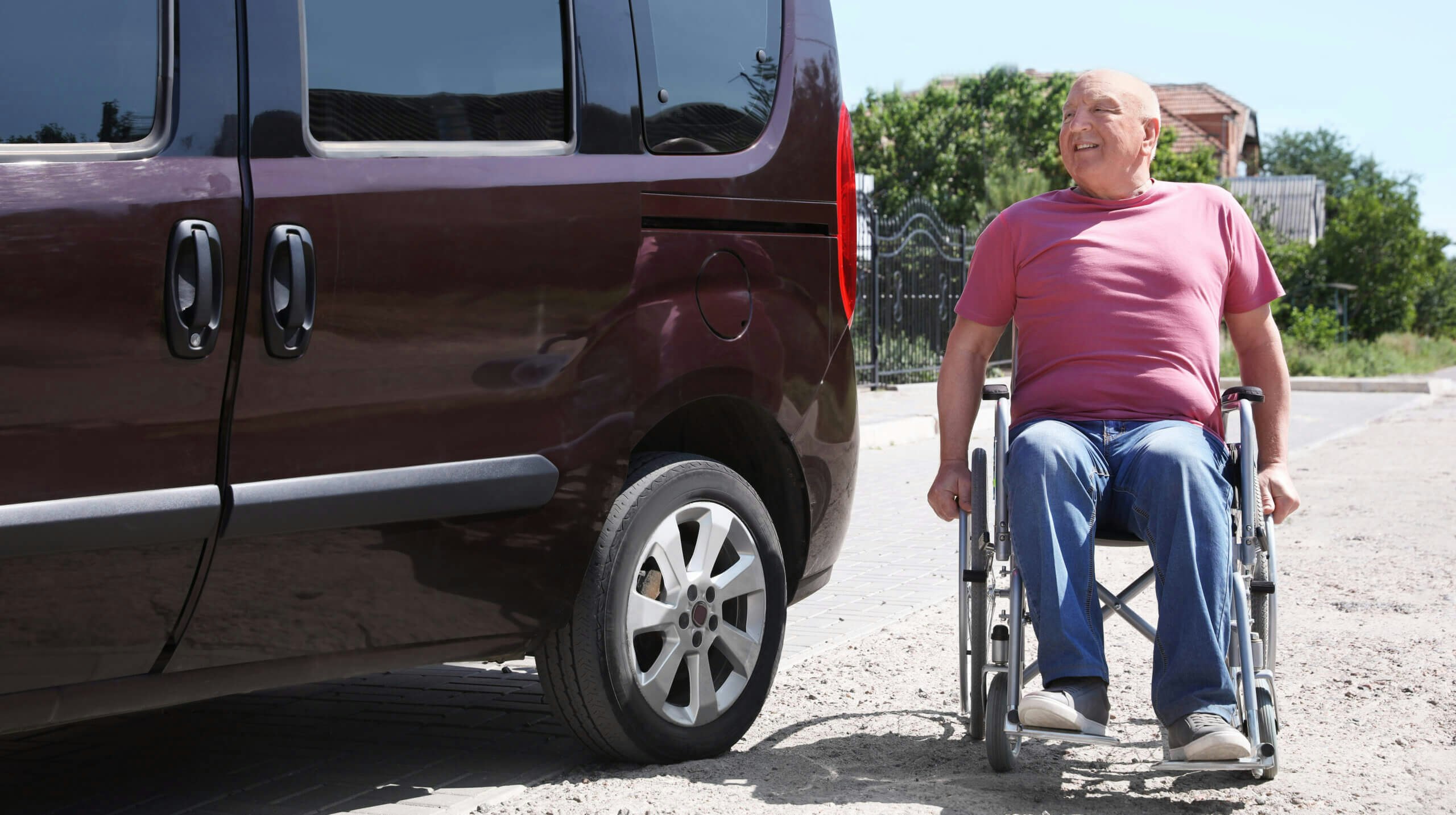 Senior man in wheelchair near van outdoors