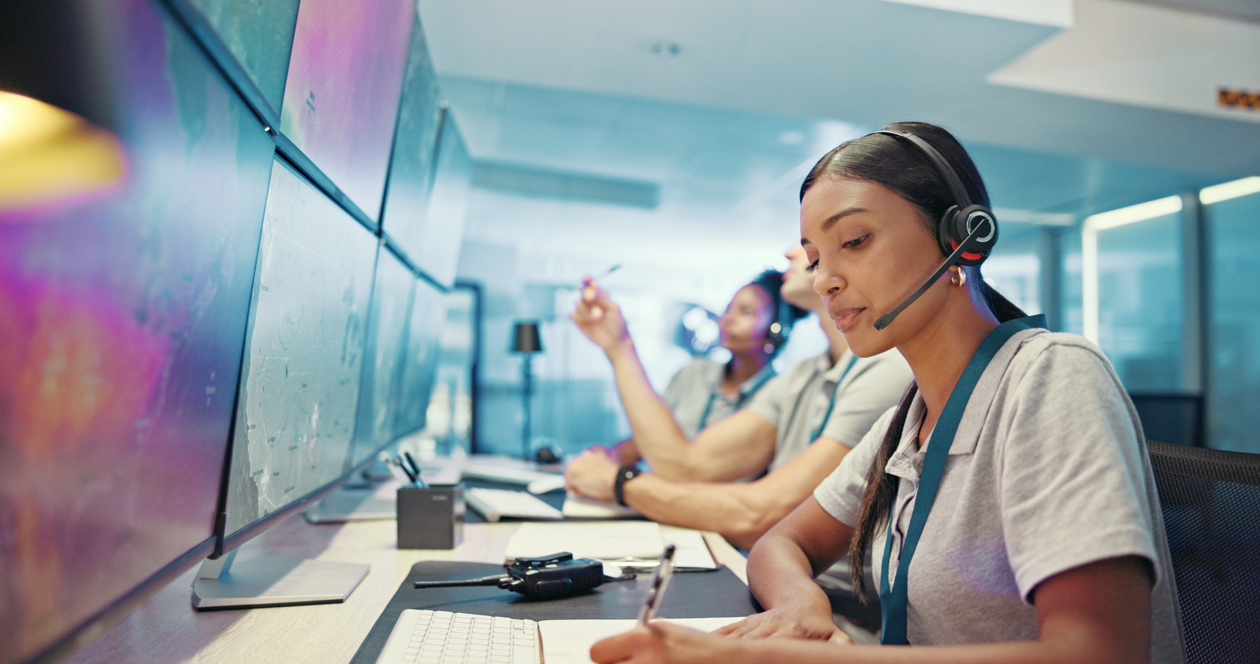 Dispatch operators with headsets monitoring transportation data on large screens