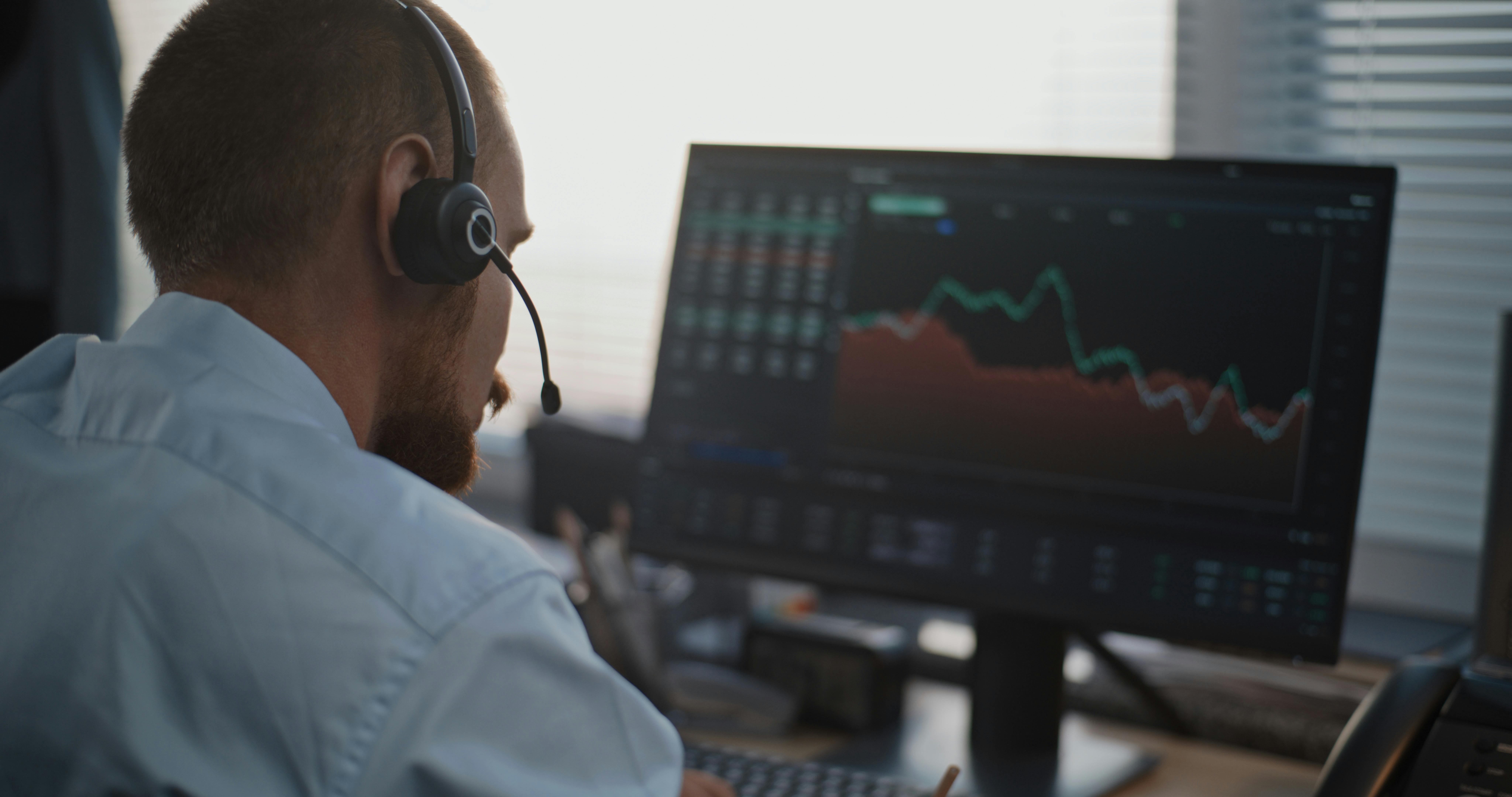 Dispatcher with headset monitoring live data on computer screen