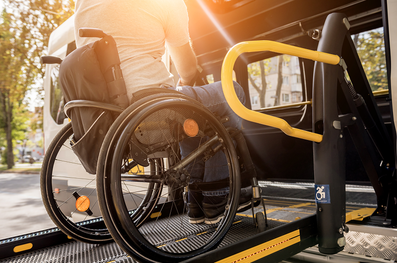 Person boarding vehicle on wheelchair