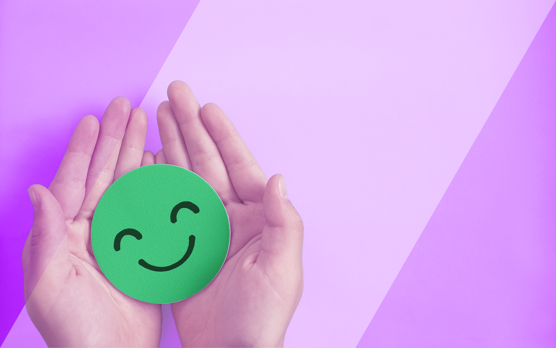 open hands holding a green smiley face