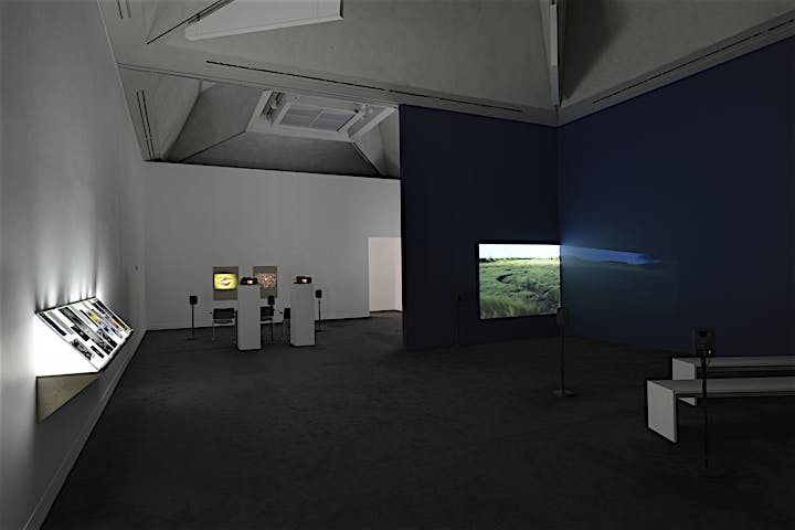 Exhibition view of lightbox installation, Addendum I (Finding Chopin: Dans l’Essex), 2014, and 2K video projection Finding Chopin: Dans l’Essex, 2014, and 35mm slide installation Postscript IV (Berlin), 2014, at Turner Prize 2014 exhibition, Tate Britain, London. September 2014 until January 2015