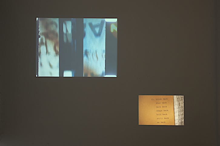 Henri Chopin and E.E. Vonna-Michell, To Ray The Rays, 1986-87, 16mm film transferred to video, sound, colour, 7 minutes 55 seconds; Tris Vonna-Michell, back segments, 2022, slide projection, 35 colour slides (35mm), audio, back segments publication by E.E. Vonna-Michell, 8 minutes 03 seconds. Installation view of Vonna-Michell: back segments at Jan Mot, Brussels, 2022, from left to right