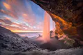 Photo of a waterfall during a sunset in winter time.