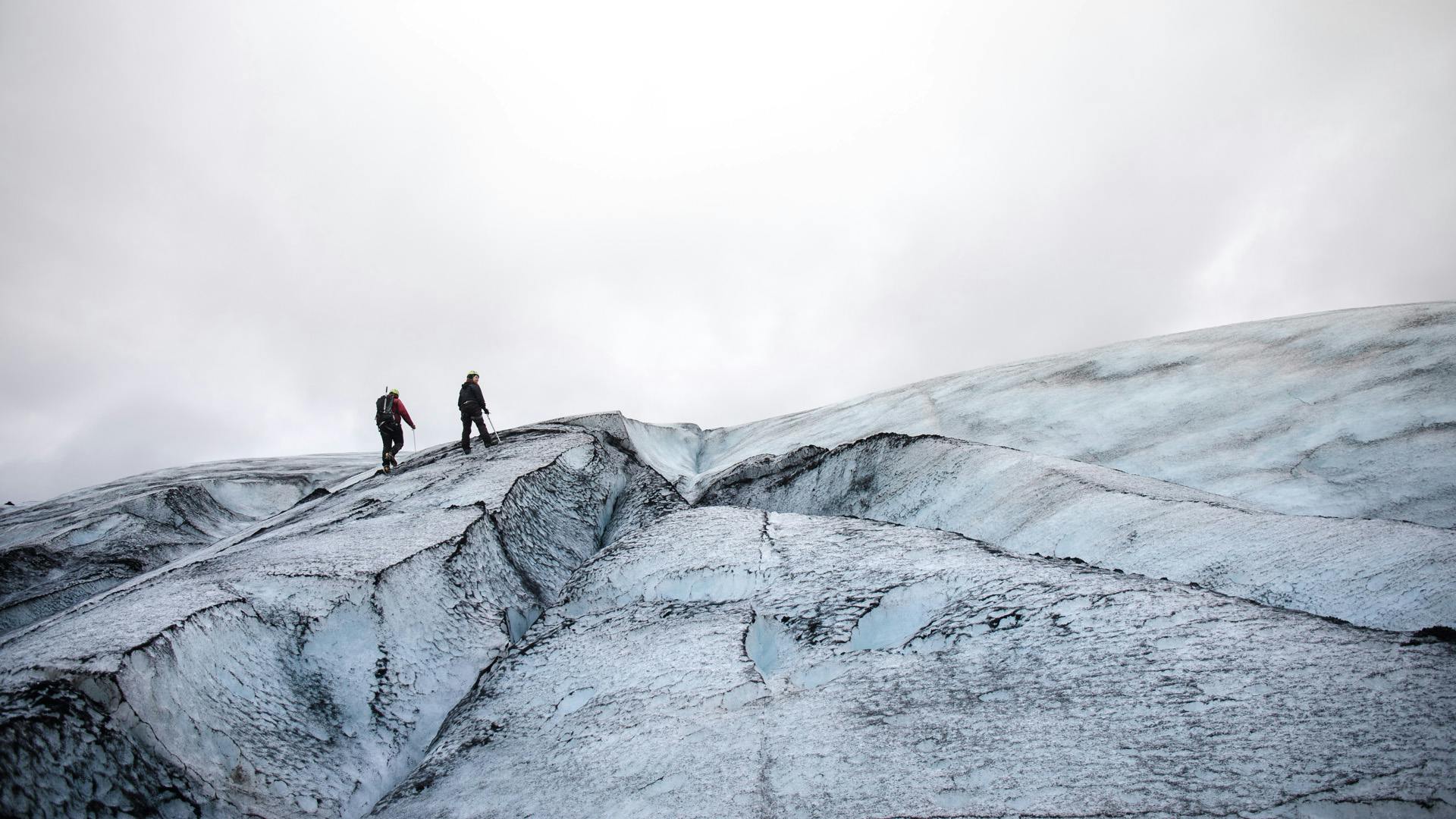 Two persons walking up on the Glacier.