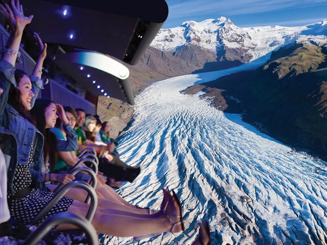 People sitting on airplane-like seats enjoying Icefall from Skaftafell