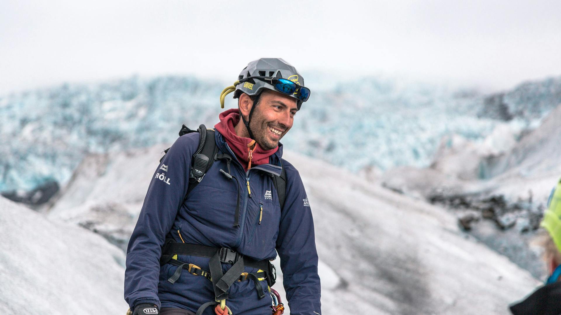 A person using a helmet while smiling at another person.