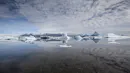 A photo of a glacier lagoon with calm waters creates a reflex.