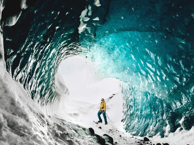 A man standing in an ice cave 