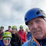 A man using a blue helmet staring at the camera.