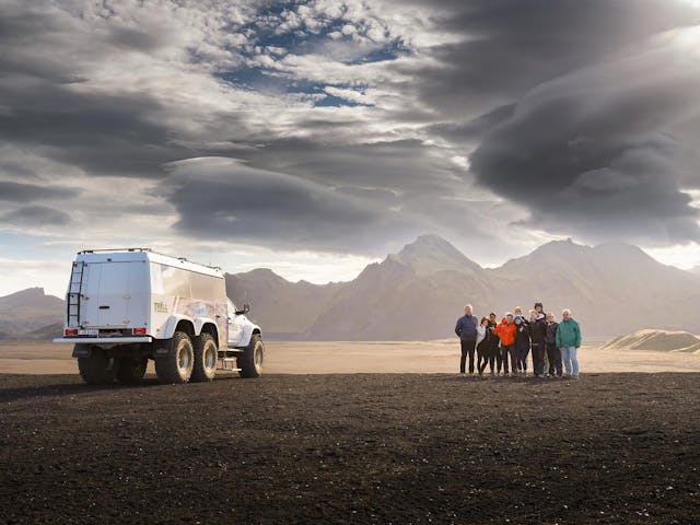 A truck near Katla Volcano Ice Cave with happy travelers. 