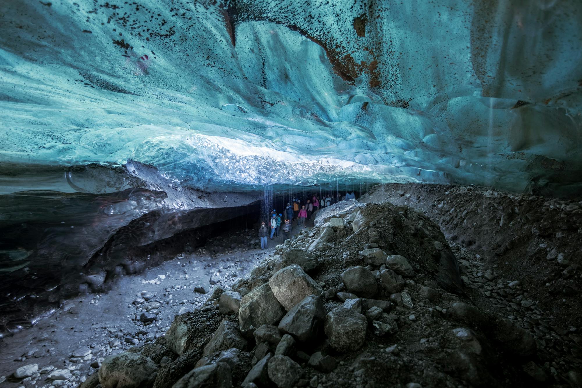 A group of people exploring an ice cave.