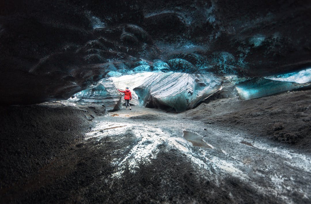Person in distance touching the pieces of ice.