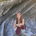 A woman near some rock formations.