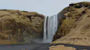 Photo of a waterfall during autumn time.