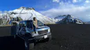 Woman sitting on top of a super jeep with Star Wars scenery on the background.