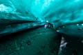 A group of people explore the inside on an ice cave.