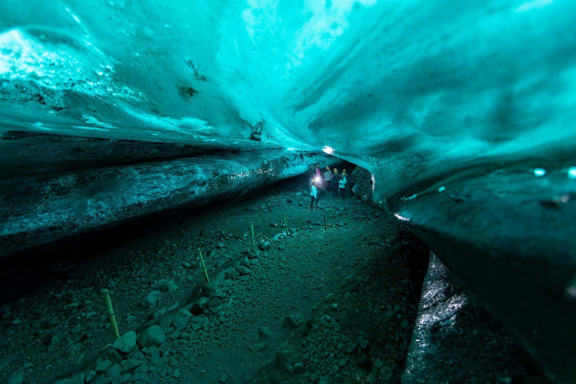 A group of people explore the inside on an ice cave.