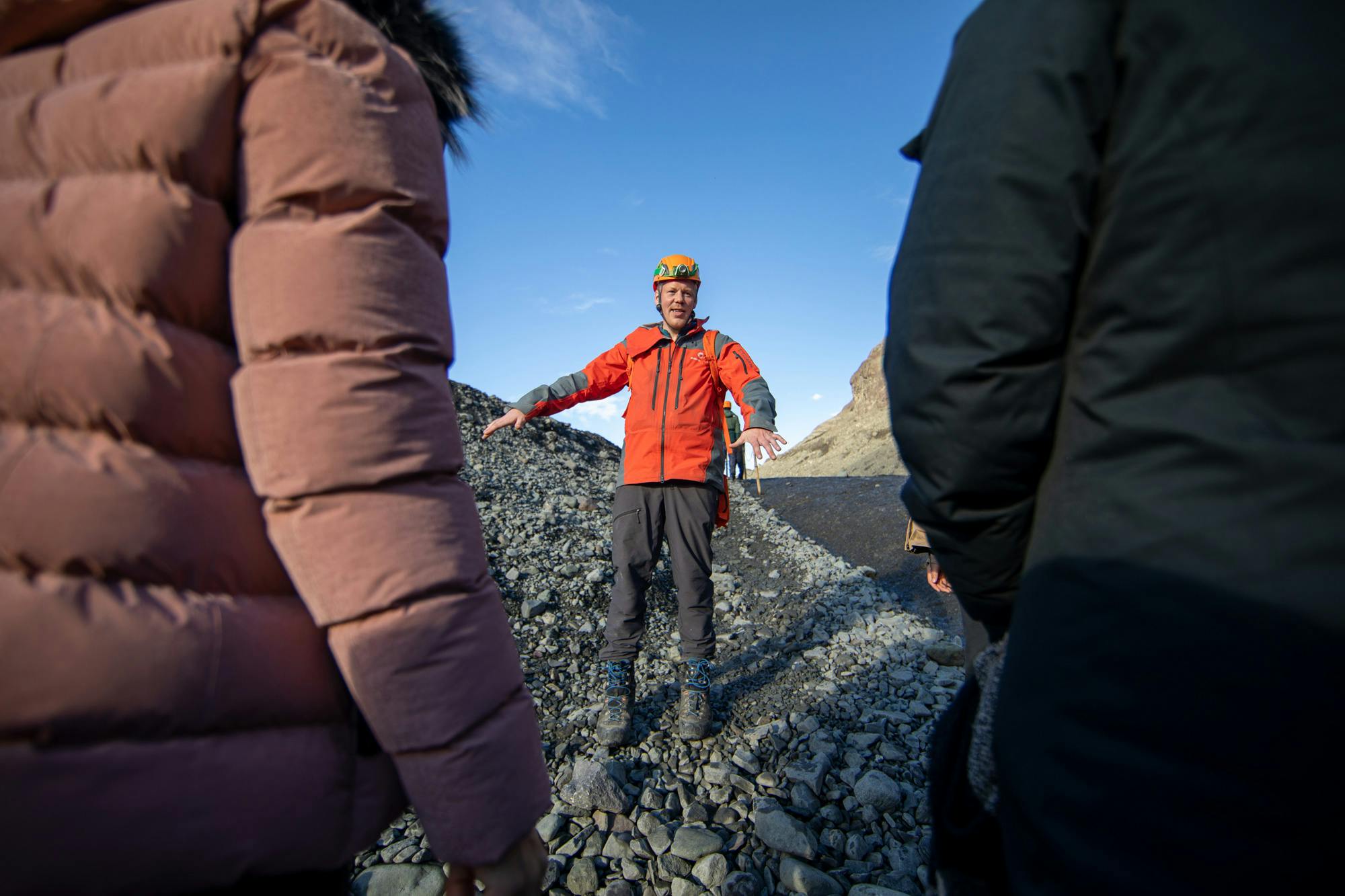 A guide giving instructions to the clients before they go inside an ice cave.