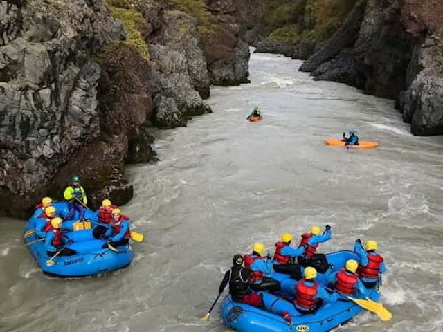 People river rafting in a glacial river
