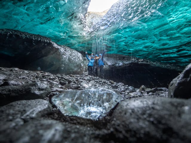 People in a blue ice cave