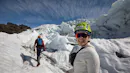 Woman smiling while doing a Glacier hike.