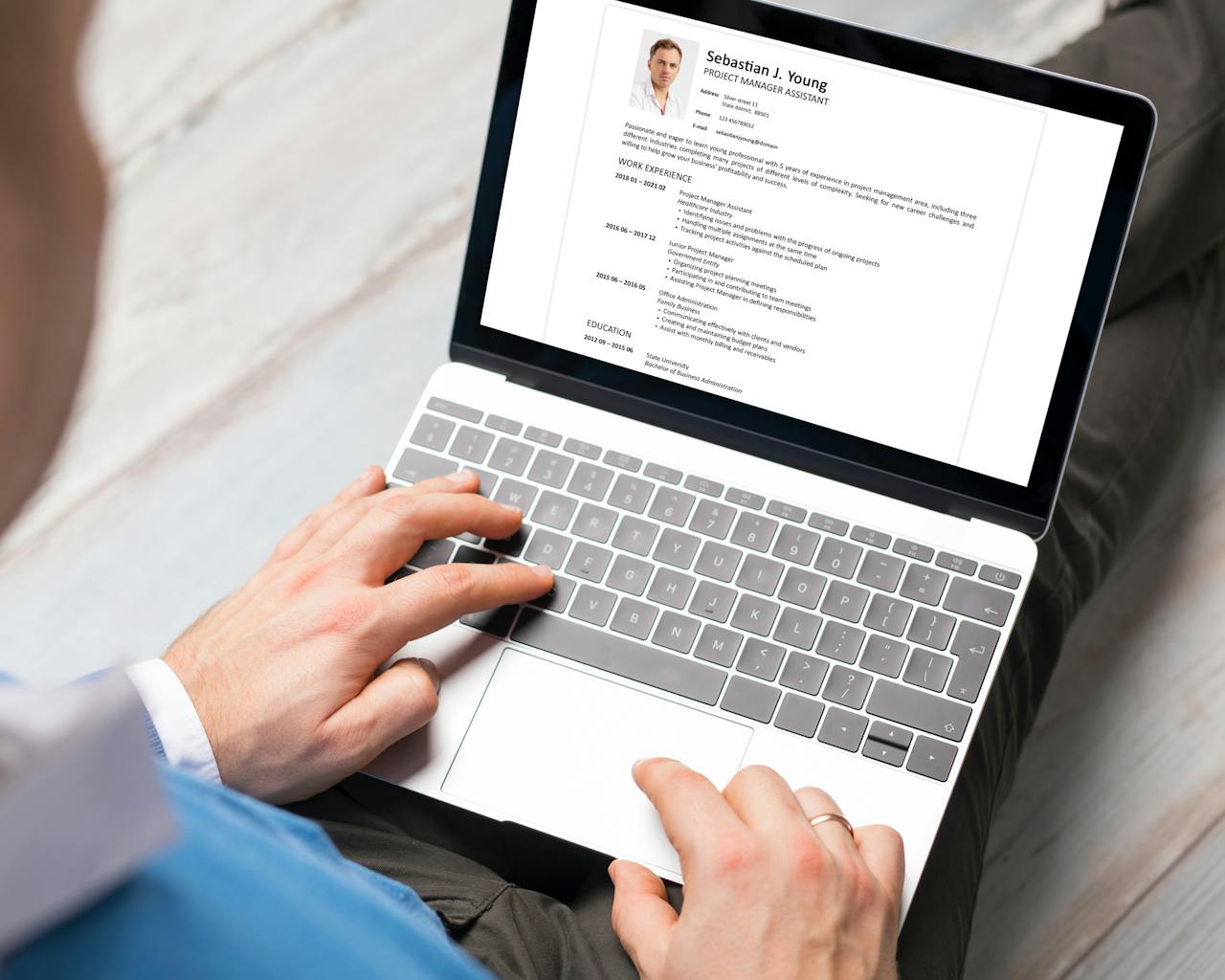 Man writing CV on laptop